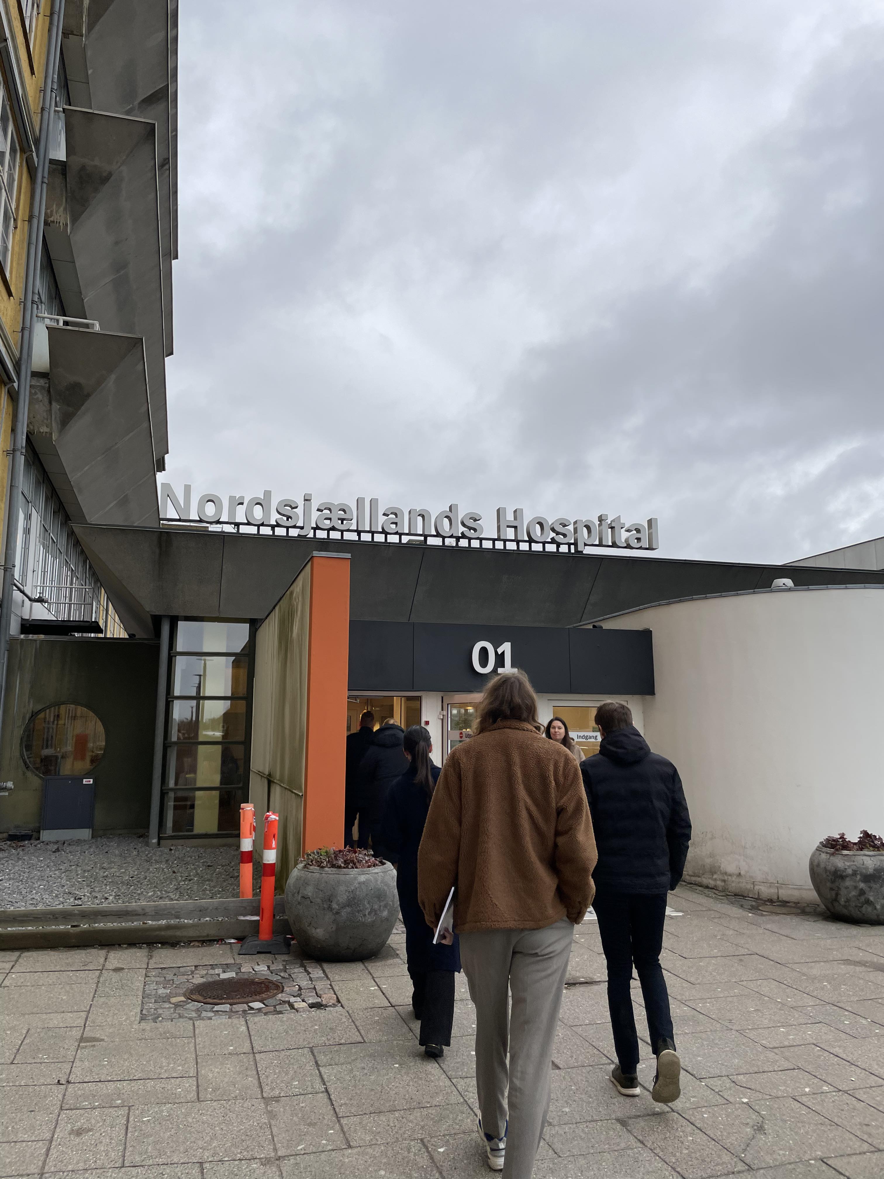 Entrance 01 at Nordsjællands Hospital in Hillerød, with people approaching