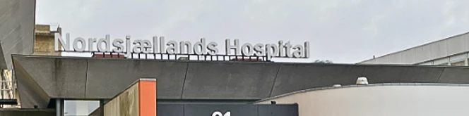 Exterior detail of Nordsjællands Hospital, showing its name above the entrance